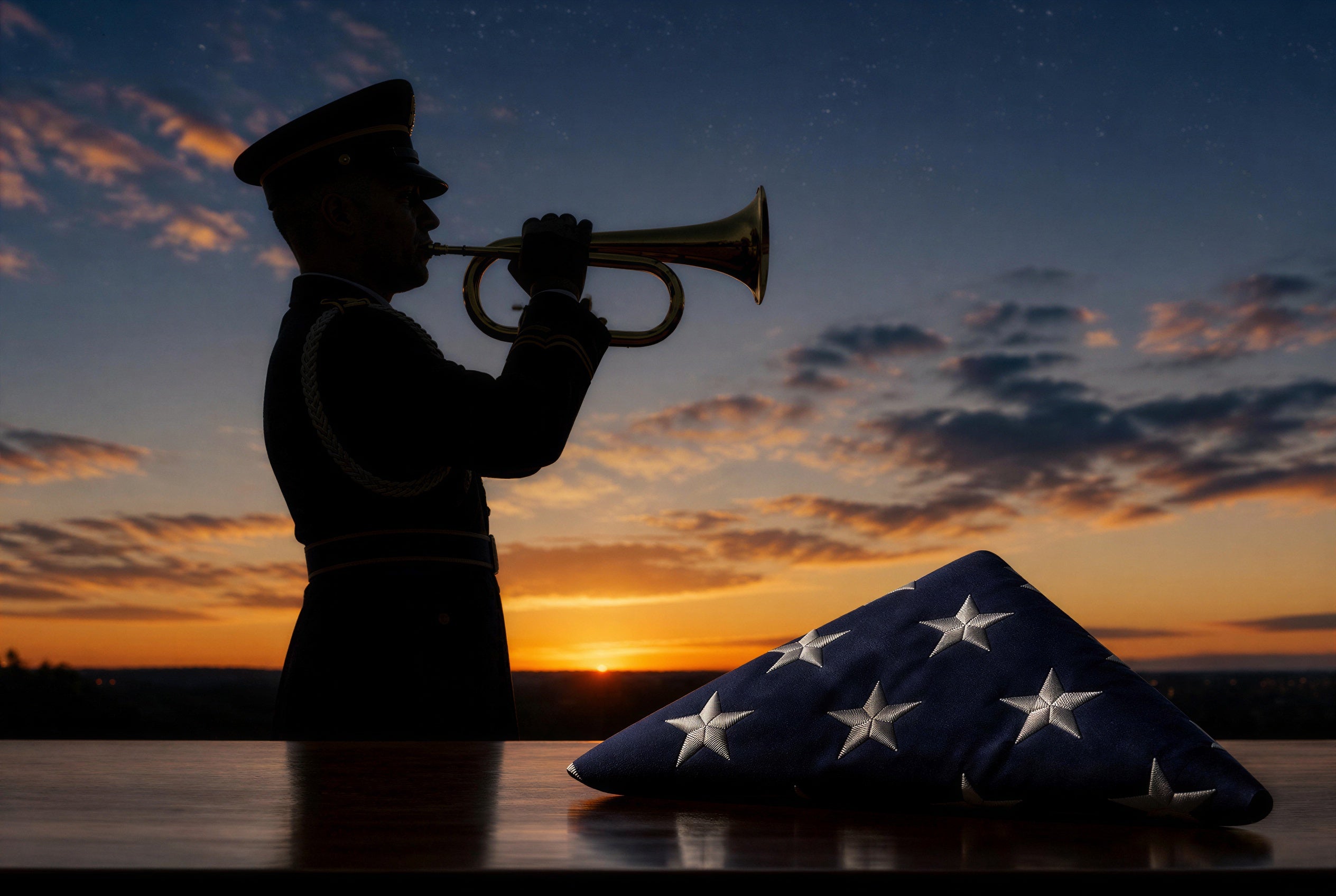 Silhouette of a military bugler playing Taps at sunset beside a folded American flag — header image for a step-by-step guide to what happens at a military funeral