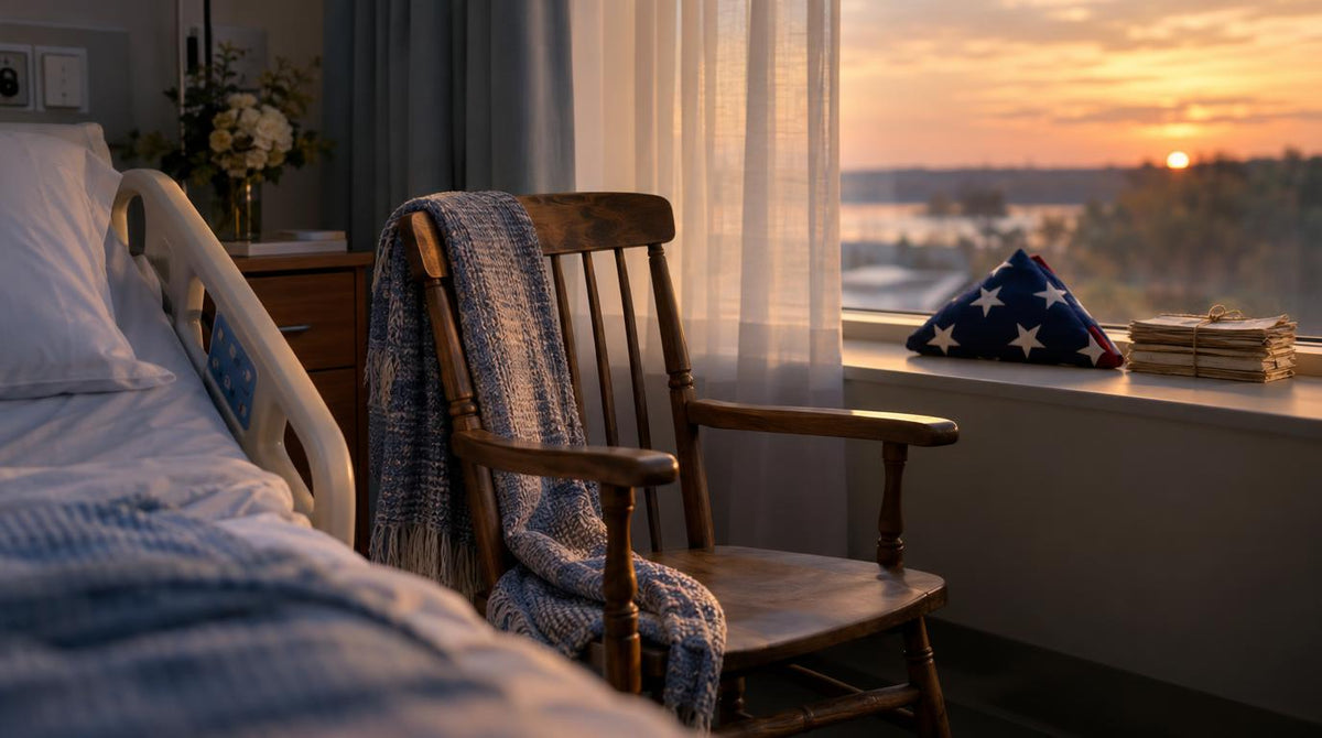 An empty chair beside a hospital bed by a window at dusk, with a folded flag and a small stack of old letters on the windowsill.
