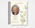 Golden Grace floral botanical memorial guest book template — front cover with soft cream background, gold page border, watercolor eucalyptus branches and white calla lilies, gold oval portrait frame, and 'Forever in Our Hearts' in flowing script; Canva editable i
