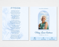Soft blue watercolor floral funeral program with an arched photo frame and elegant script name on the front cover, and the original "Let Me Go Gently" tribute poem on the back cover, Standard size