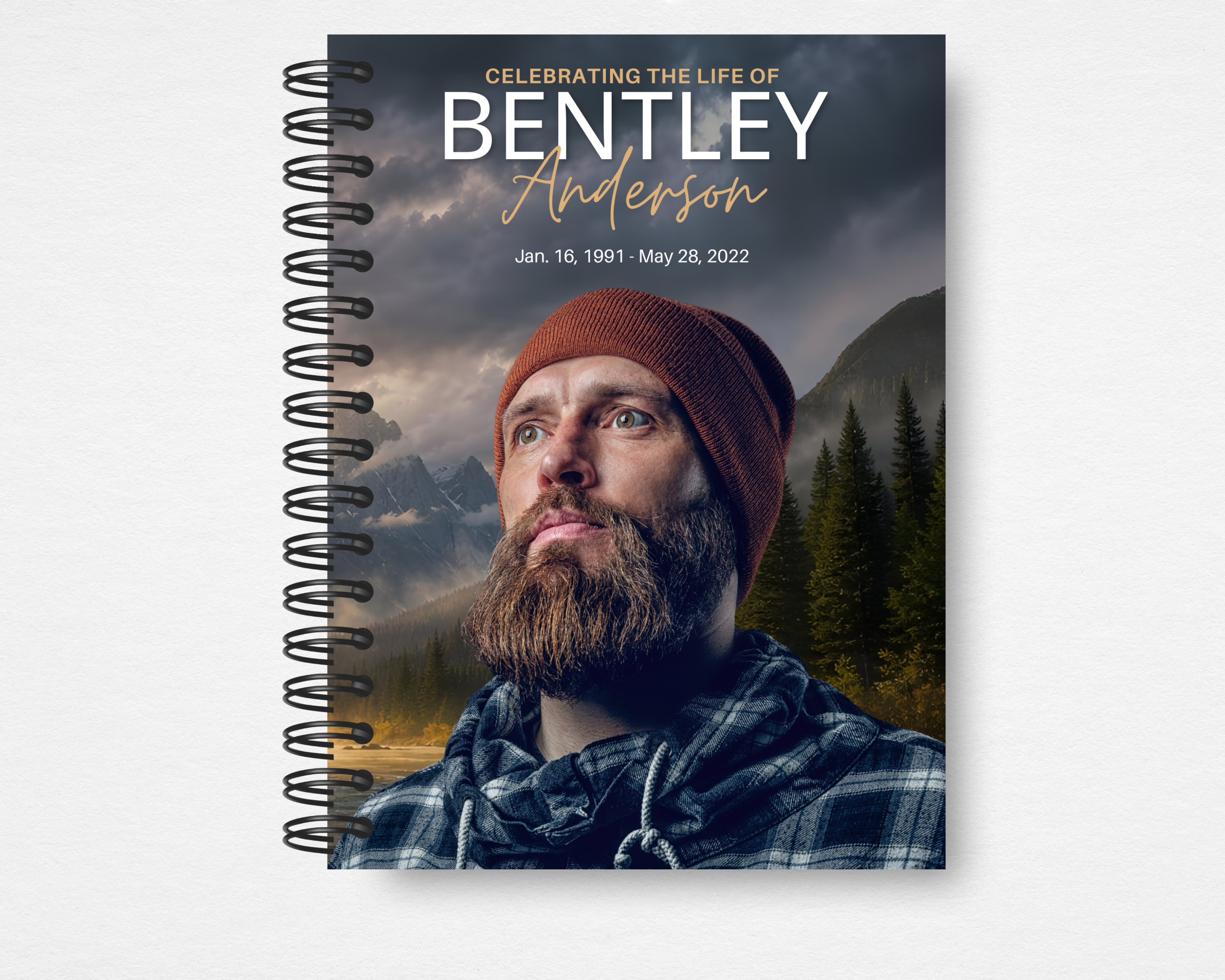 Summit & Sky — Eagle's Ridge memorial guest book cover — man in rust beanie and flannel, portrait blended into stormy mountain landscape with dark pines and golden light breaking through clouds, bold white and gold script name, spiral bound